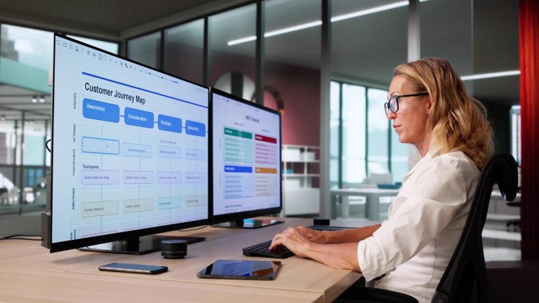 Woman working on a computer while analyzing a CRM customer journey.